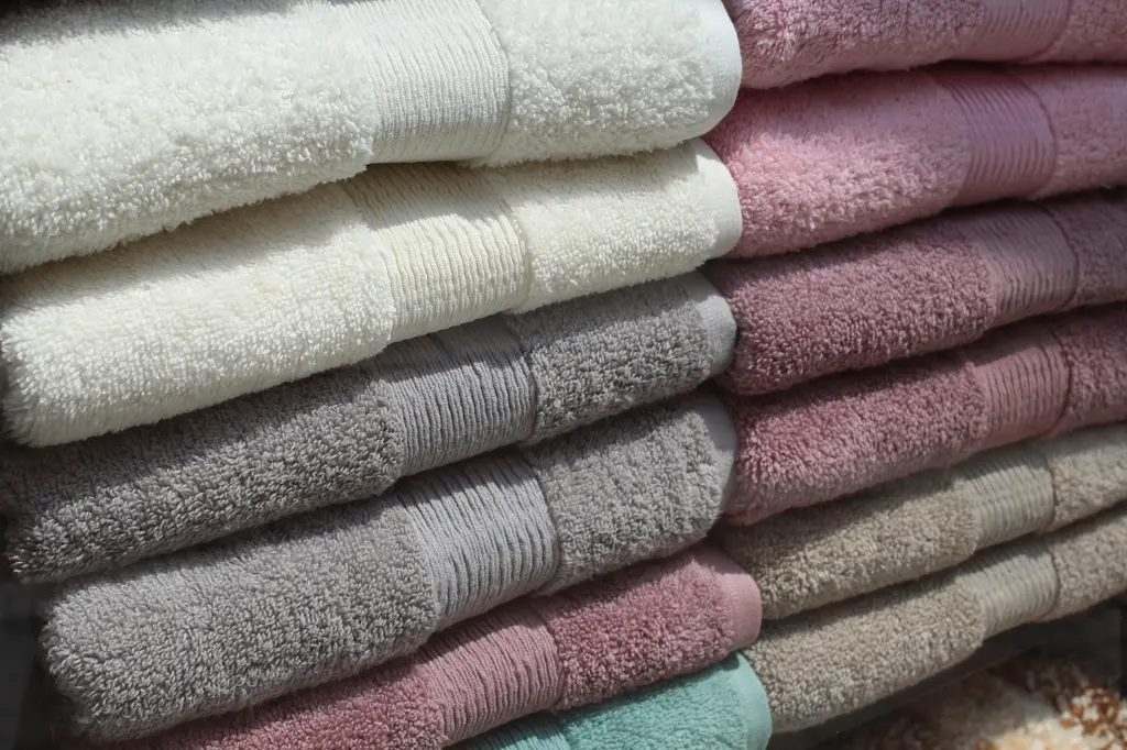 Stacks of soft folded towels in neutral and pink tones