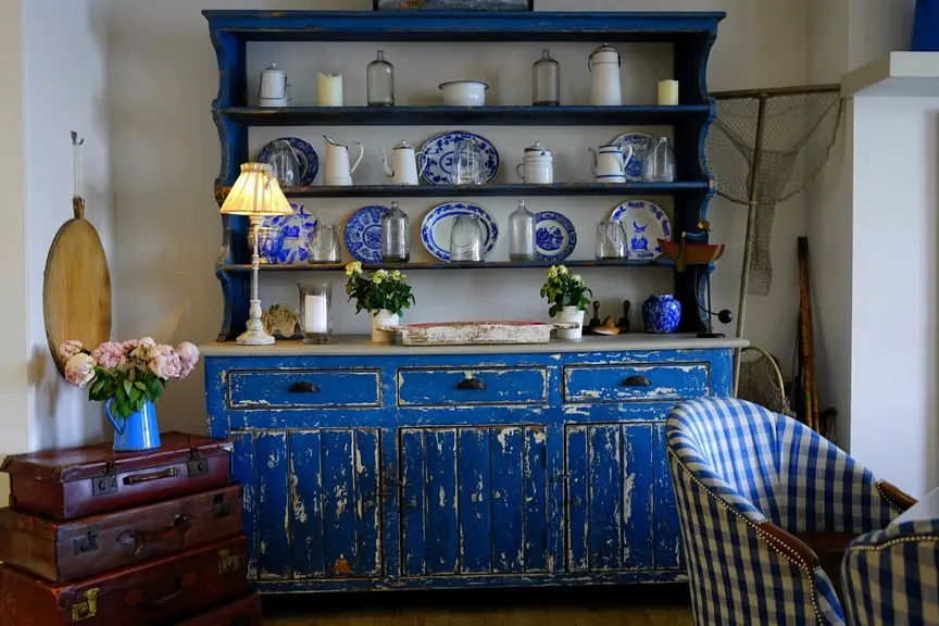 Vintage blue painted kitchen dresser with blue-and-white plates