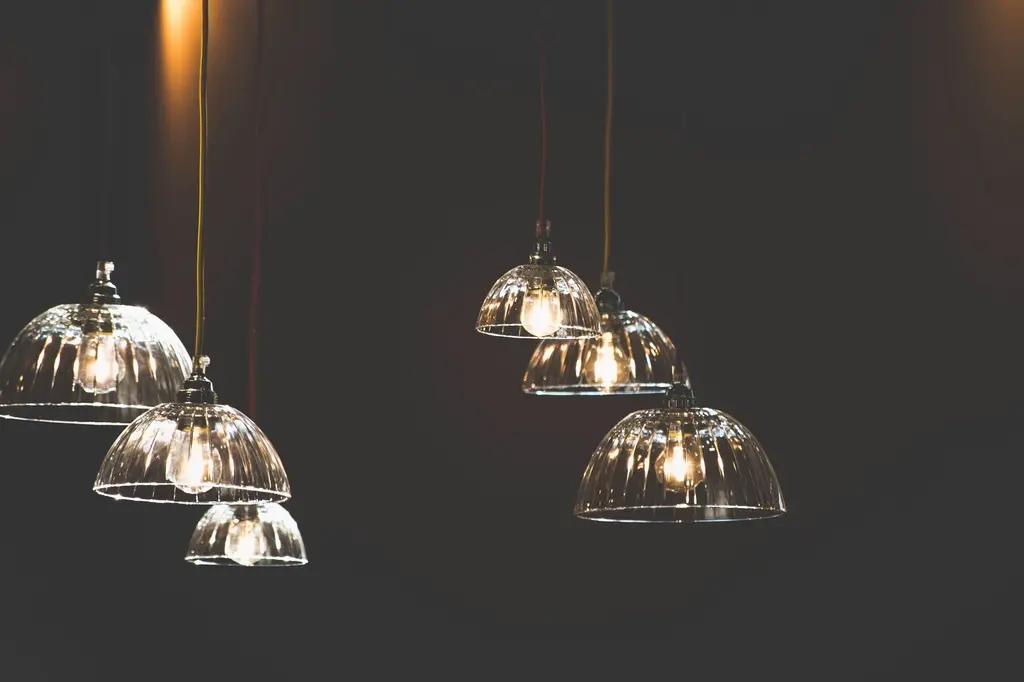 Clear glass pendant light shades glowing above