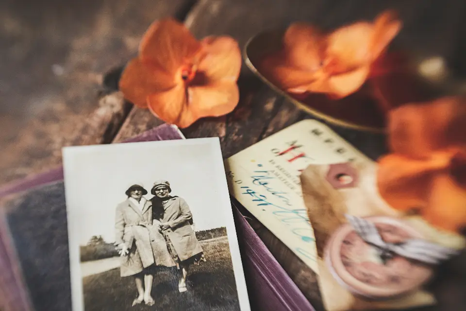 Vintage black-and-white snapshots among dried flowers