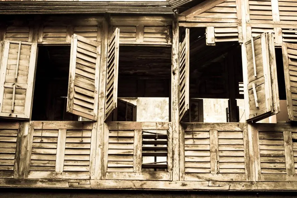 Weathered wooden shutters and window frames on an old building