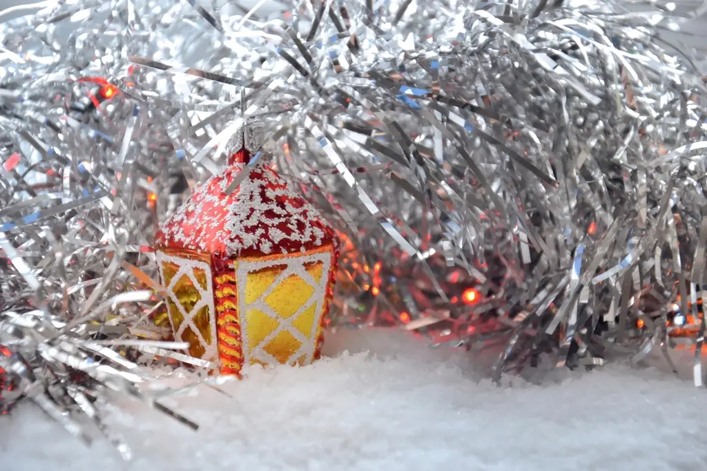 Silver vintage-style tinsel with a small red lantern ornament